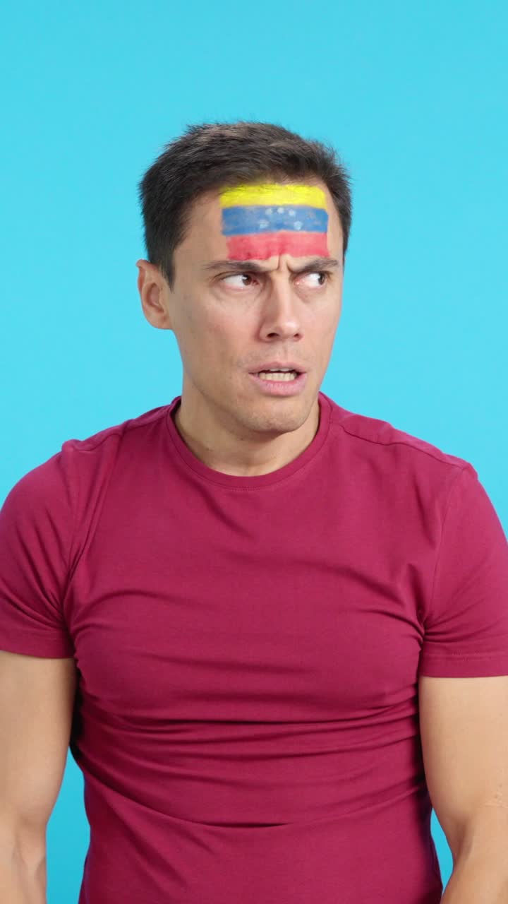 Man cheering for Venezuela during a match that is lost