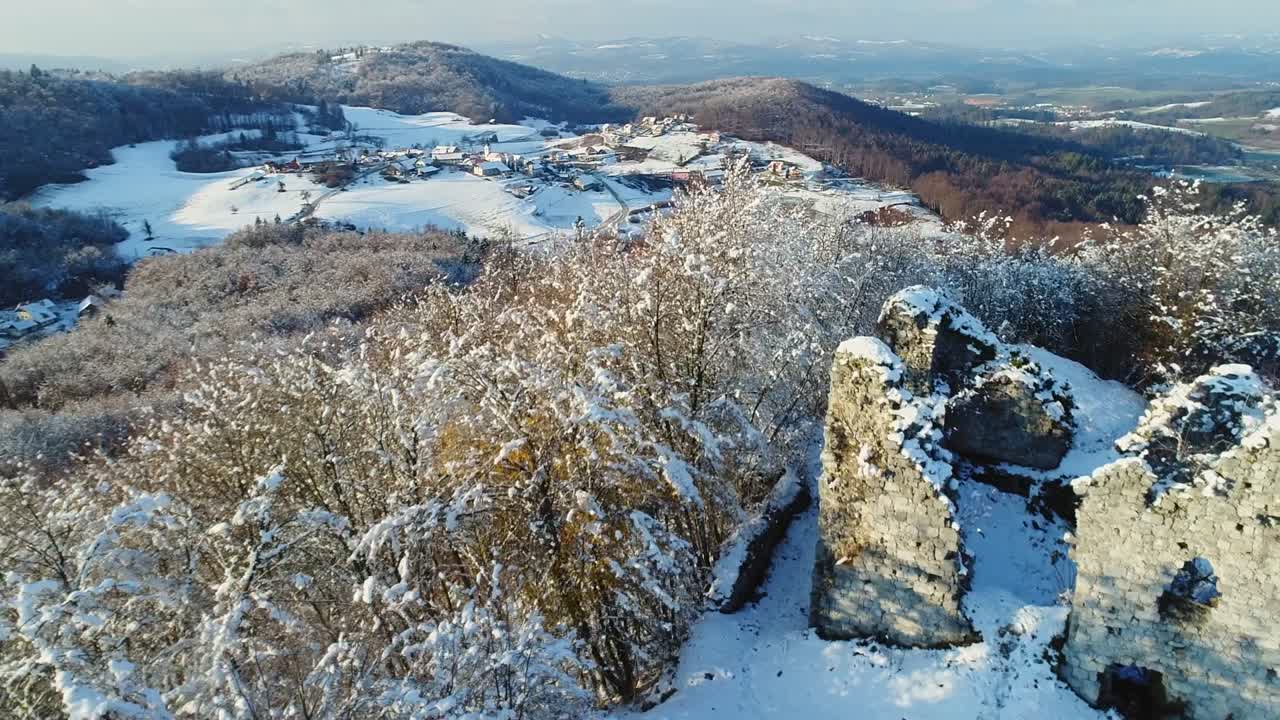 Drone flyover shot of Ruins of Castle Sumberk in the snow