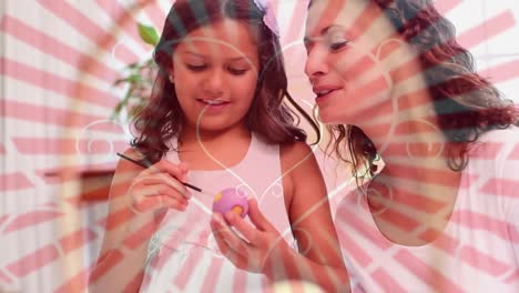 mother and daughter painting easter eggs