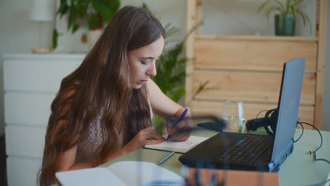 woman taking online course notes