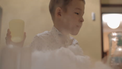 child is happy to play with liquid nitrogen white smoke