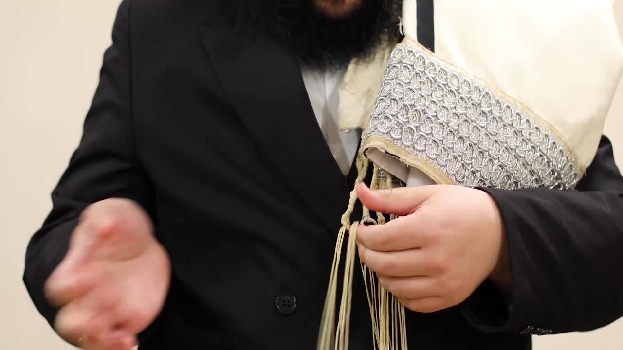 Jewish man checking tzitzit slow motion