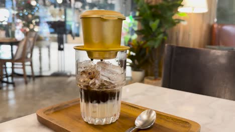 coffee dripping into glass with ice