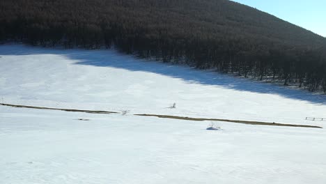sunshine over mountains valley covered with fresh white snow during winter season