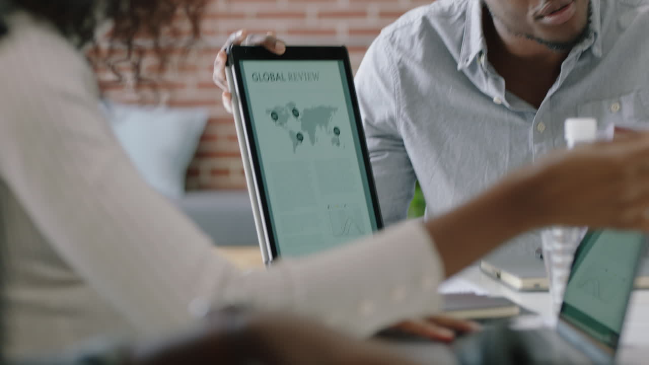 african american business people meeting brainstorming team leader man sharing ideas for creative startup project presenting strategy using tablet computer training colleagues in office presentation