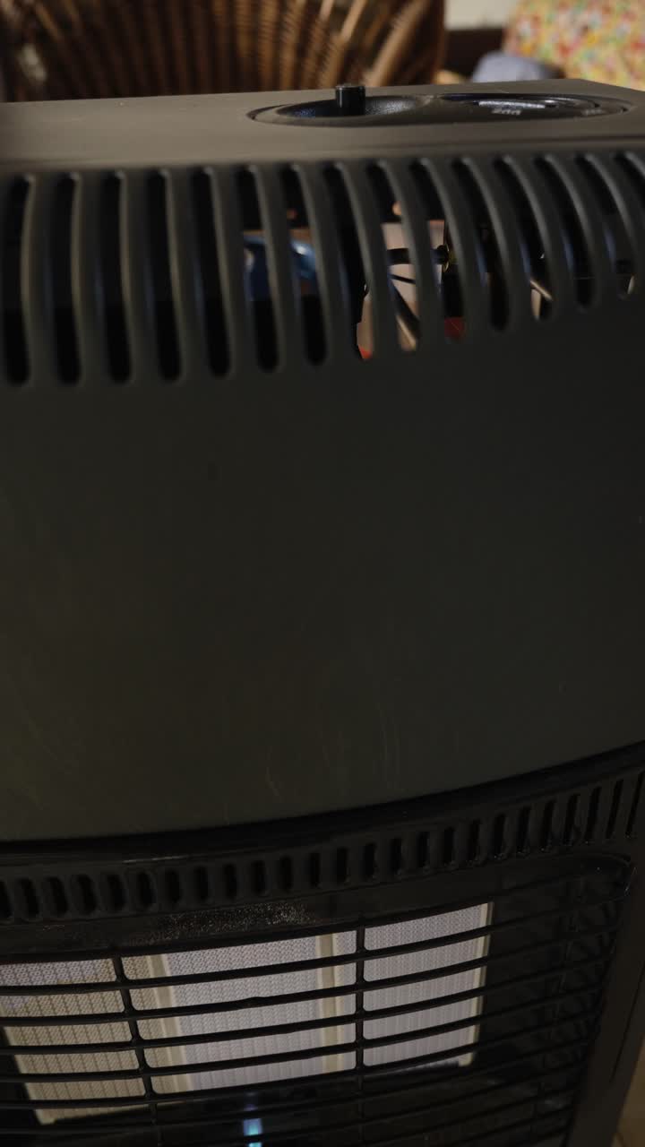 Ignition moment as pilot flame spreads across the portable gas heater element. Ideal for appliance operation and domestic heating use