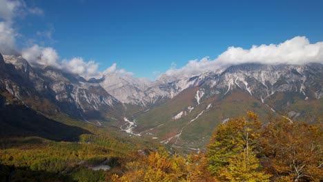 mountains covered in white clouds in autumn, cinematic revealing of breathtaking alpine panorama