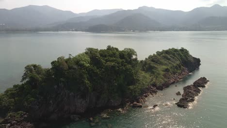 Aerial-birds-eye-view-orbit-drone-shot-of-a-small-deserted-tropical-island