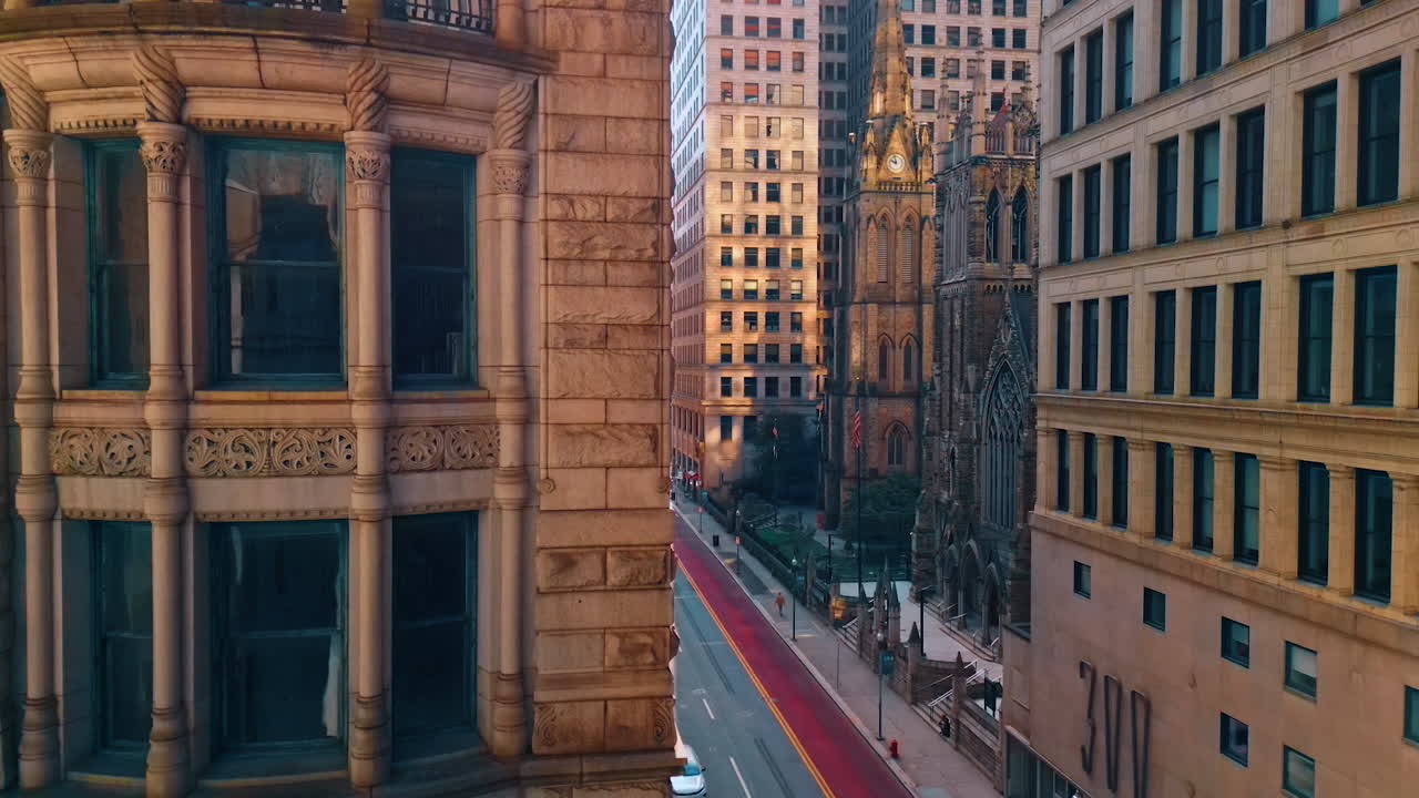 The Granite Building on Sixth Ave in Pittsburg, Pennsylvania, USA. The German National Bank building from low angle view. Aerial perspective on the street with a stunning old cathedral