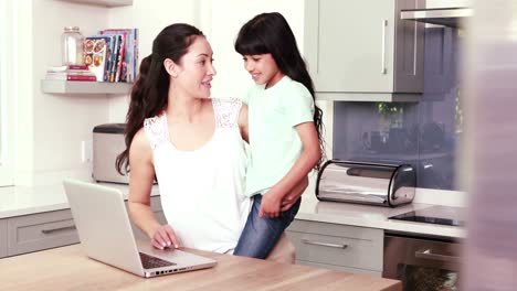 Mother-and-her-daughter-using-laptop-