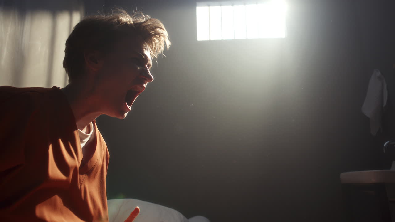 Distraught Female Inmate Shouting in Distress in Prison Cell