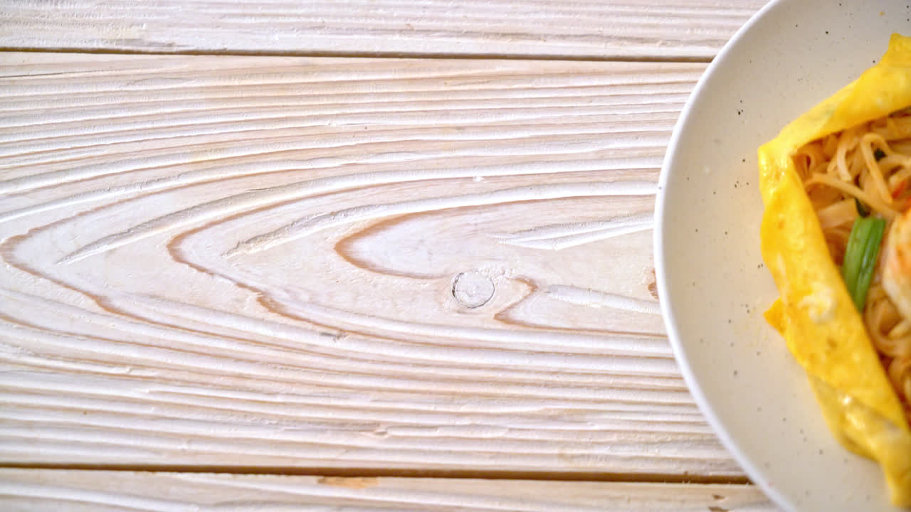 Thai stir fried noodles with shrimps and egg wrap (Pad Thai) - Thai food style