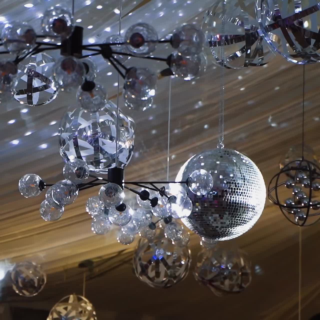 Numerous Disco Balls and Reflective Light Fixtures Adorning a Ceiling