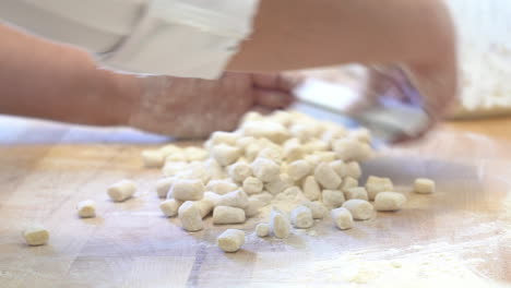 human-hand-making-little-piece-of-a-typical-italian-pasta-with-flour-eggs-and-water