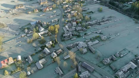 aerial of small idyllic village witow in poland during sunrise, shade from hill