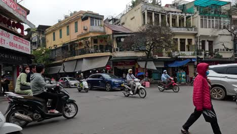 pedestrians and vehicles navigating a busy city crossroad.