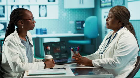 black female specialist discussing health care concerns with a young patient