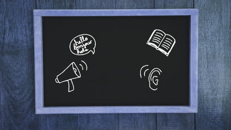 multiple school concept icons on black board