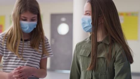 tracking video of two friends walking down the school corridor