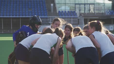 female hockey players preparing match on the field