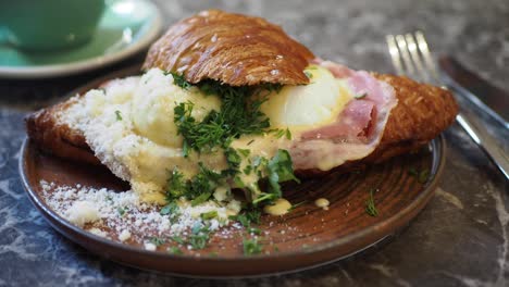 delicious croissant sandwich with eggs benedict