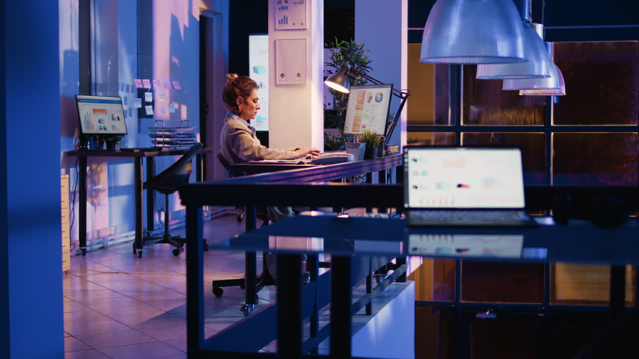 Woman Working Late in Modern Office