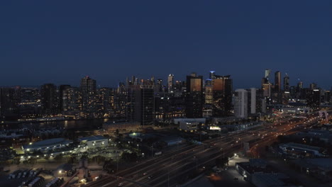 Melboune-City-at-dusk-aerial-rising-shot-highways-in-foreground