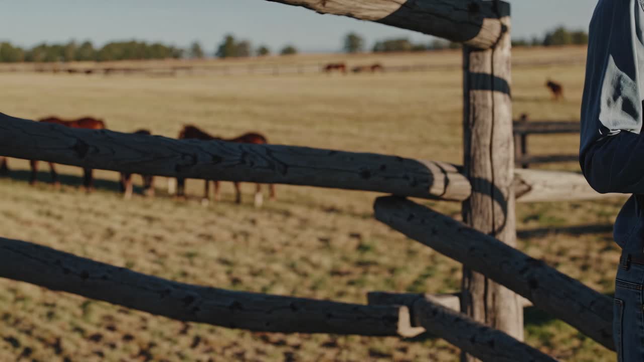 Cowboy Taking a Picture in a Field