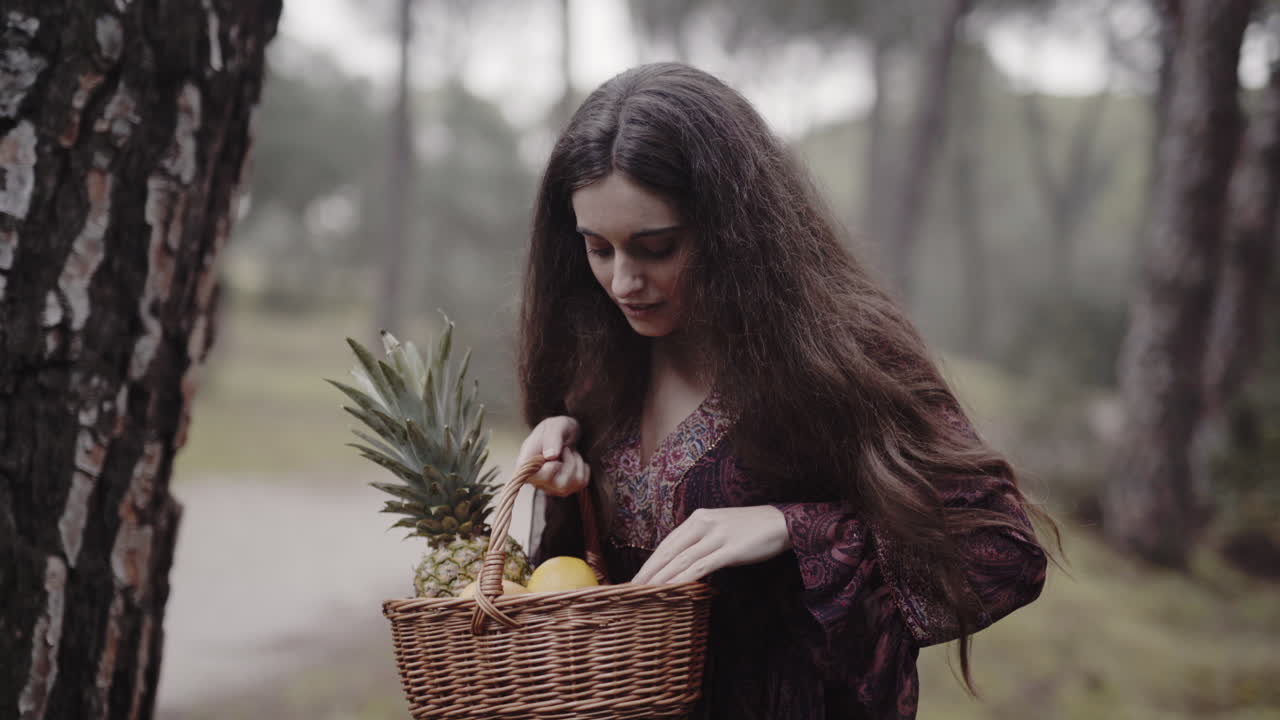 Surprised shy spanish housewife checking fruit basket gift in the woods