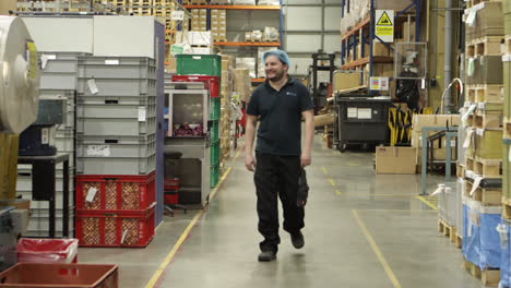 caucasian male warehouse worker walking and smiling