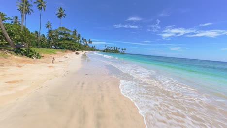 paradise beach in dominican republic, fpv drone flying above it