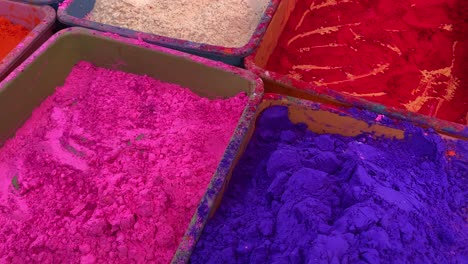 close up shot of pink and blue colored gulal or holi powder sold in local shop in india