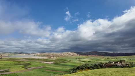 rural landscape with mountains green field rain clouds above morocco