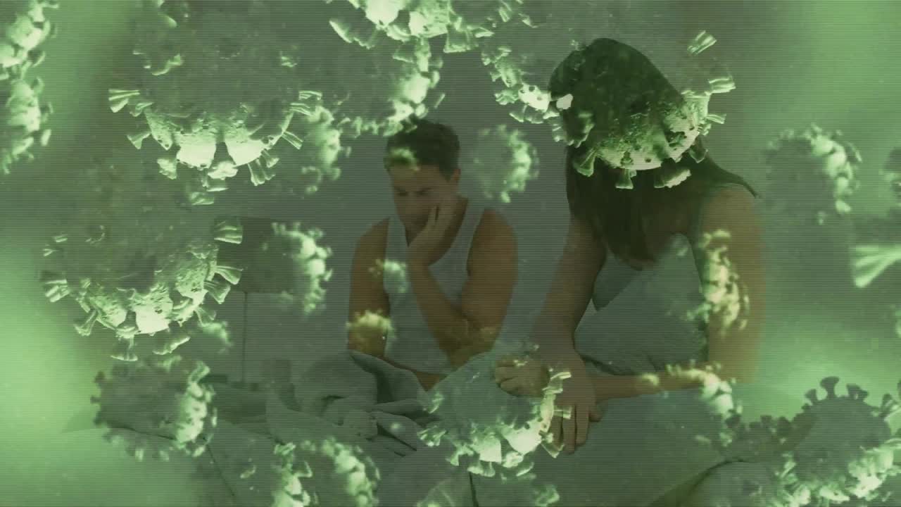 코로나19 세포가 침대에서 싸우는 커플을 상대로 움직이는 디지털 복합 비디오