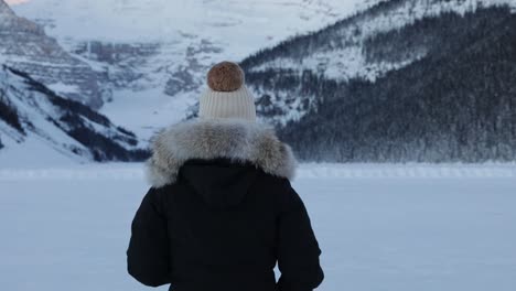 Woman-enjoying-winter-scenery,-Surrounded-by-Mountains-and-Snow,-Banff,-Slow-motion-shot