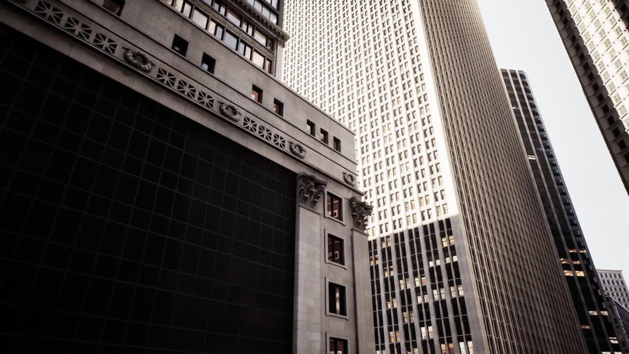 Tall buildings reach towards the sky in a bustling urban environment