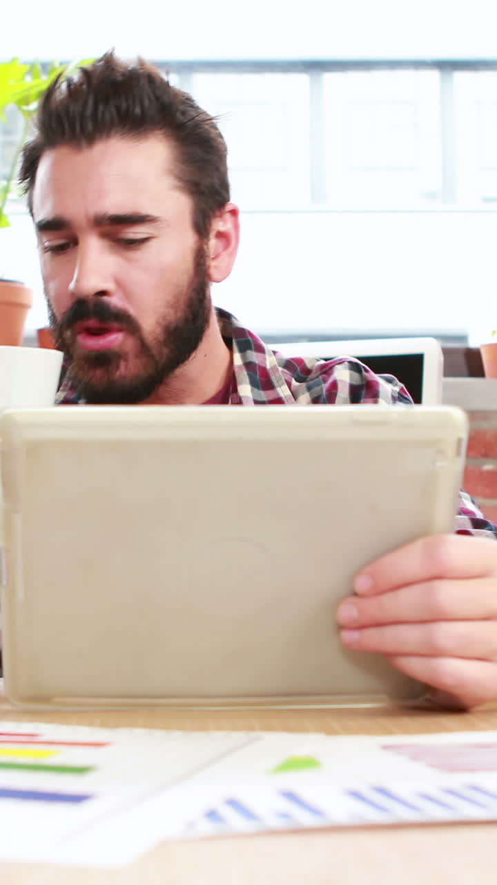 Casual businessman using tablet pc
