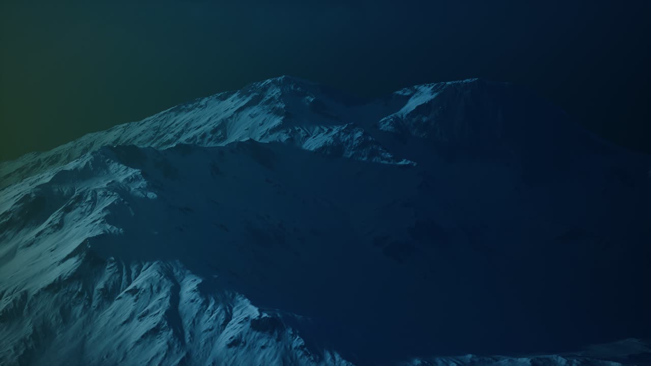 Dramatic dark rocky mountain with patches of snow in storm