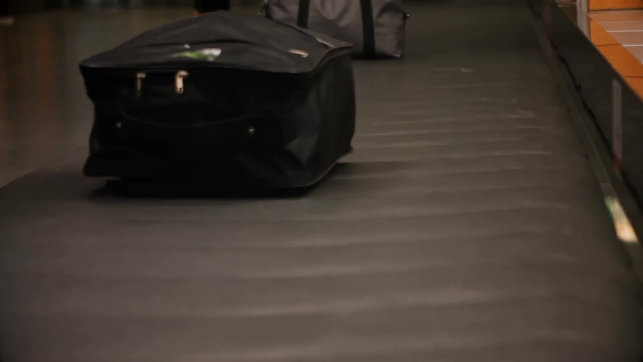 Commuters picking their luggage from baggage claim area 4k