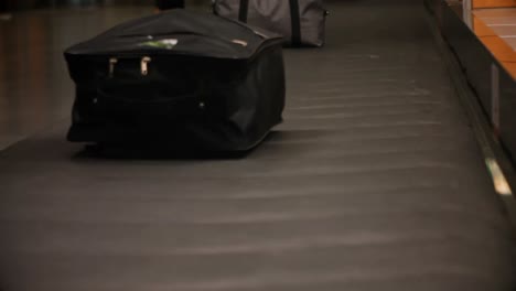 commuters picking their luggage from baggage claim area 4k