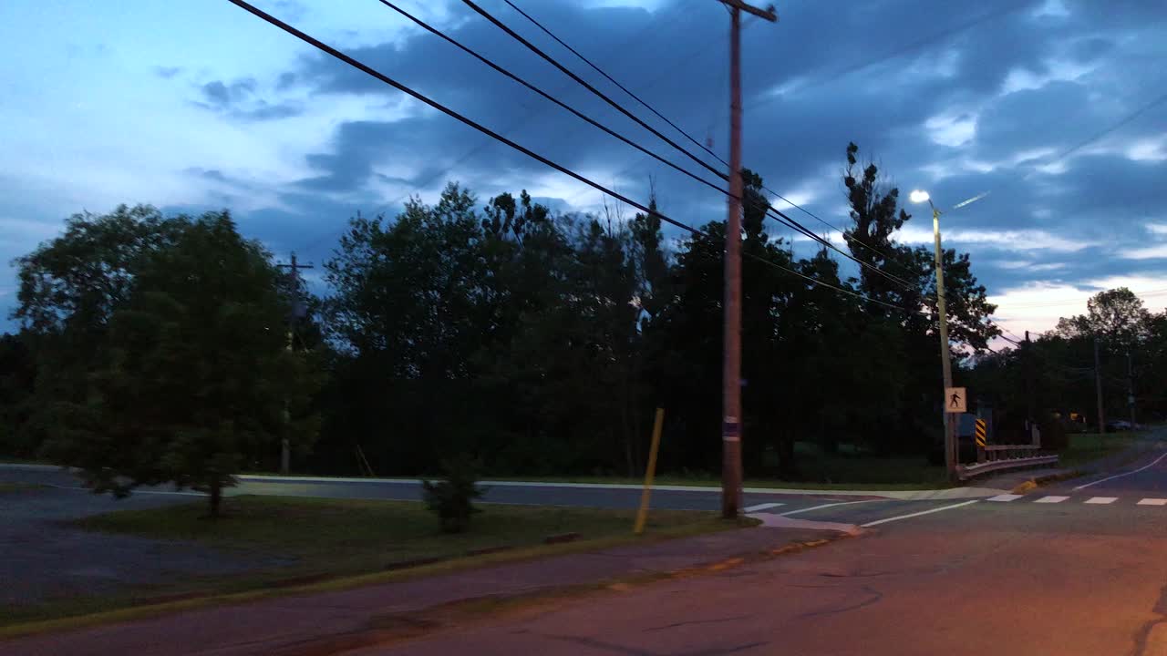 View from the drivers window while driving through a rural town past an empty church