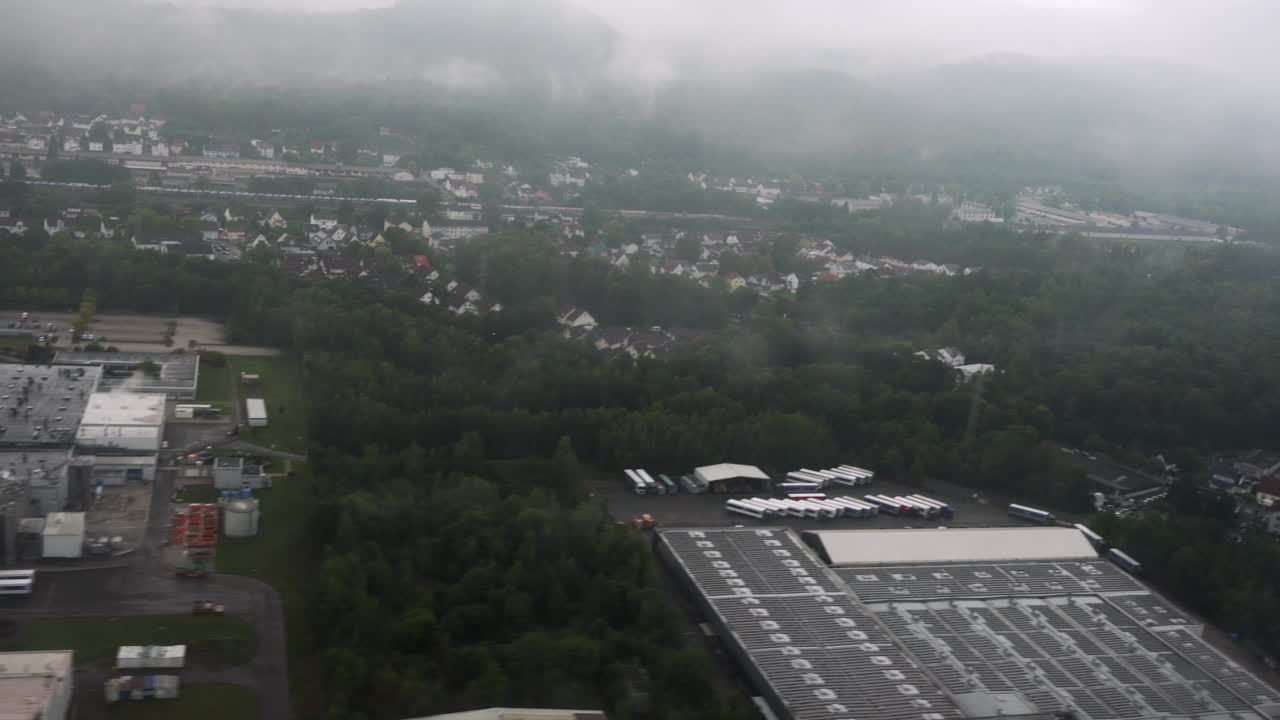 Low clouds blanket the rugged German mountains as the aircraft descends through the fog. A moody and cinematic approach shot capturing the beauty of overcast terrain before landing