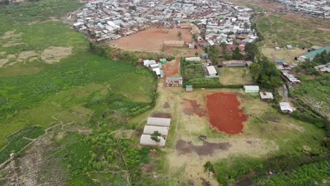 Kids-playing-in-slums-of-Kibera-Nairobi-Kenya,-footage-pitch-in-the-slums-of-kibera,-Settlement-of-kibera-houses