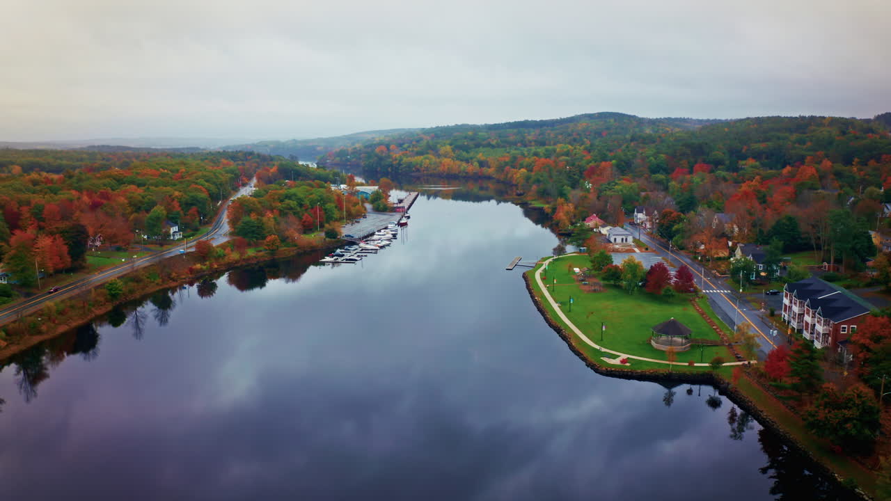 Aerial drone shot over a local town next to a river in Nova Scotia, Canada.
Bird's eye view over the autumn landscape. Colorful trees foliage.
