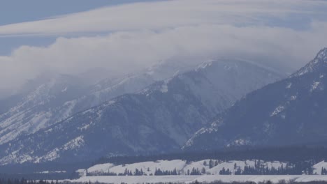 large distant mountains with clouds over the summits