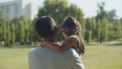 Rear-view-of-Asian-father-walking-with-his-little-daughter