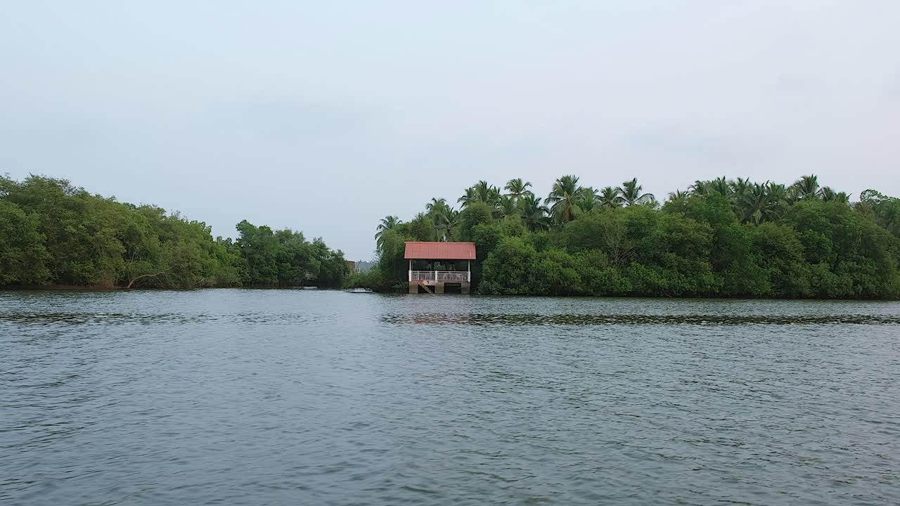 This shot of a single house on the side of the river on Goa, India.