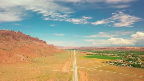 Wide-aerial-drone-shot-over-a-desert-community-outside-Moab,-Utah