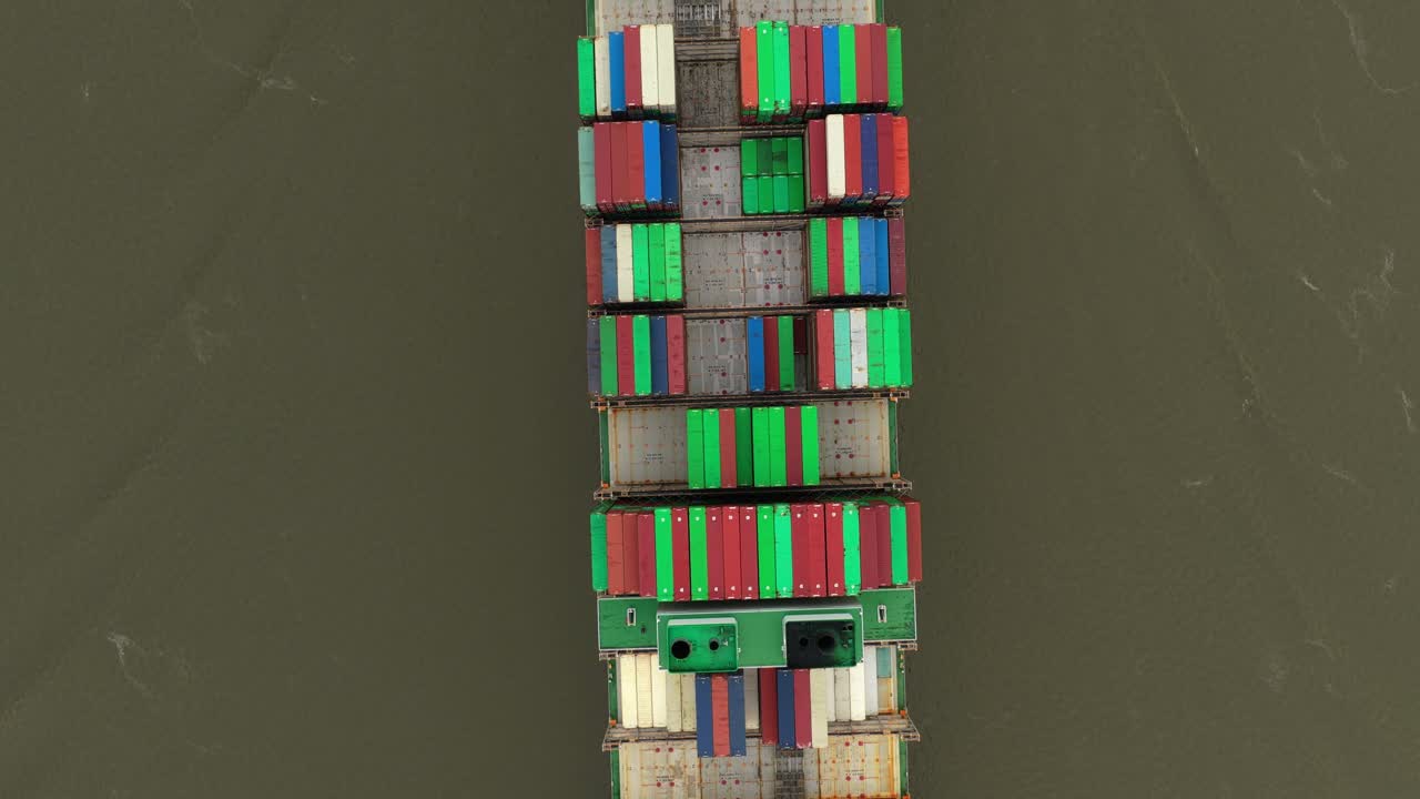 Drone shot of cargo ships navigating Elbe River trade routes, Germany