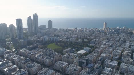aerial view of the coastal town of bat yam on the shores of the mediterranean sea as panorama skyline and urban seascape, israel. top view of residential city view middle east buildings and streets shot houses at the horizon.